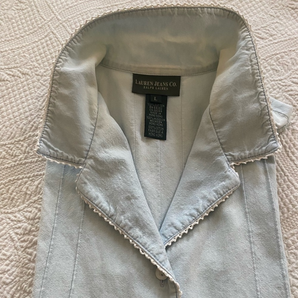 Light blue sleeveless gentle worn cotton blouse